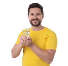 Happy man holding glass of water with lemon on white background