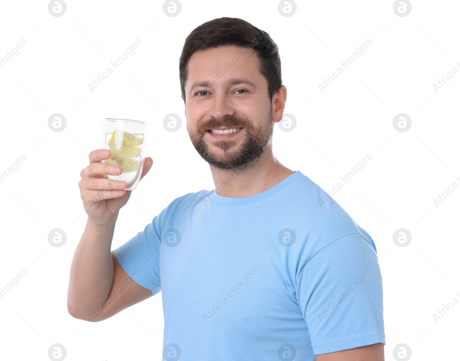 Photo of Happy man holding glass of water with lemon on white background