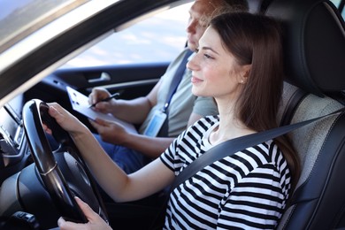 Driving school. Student passing driving test with examiner in car