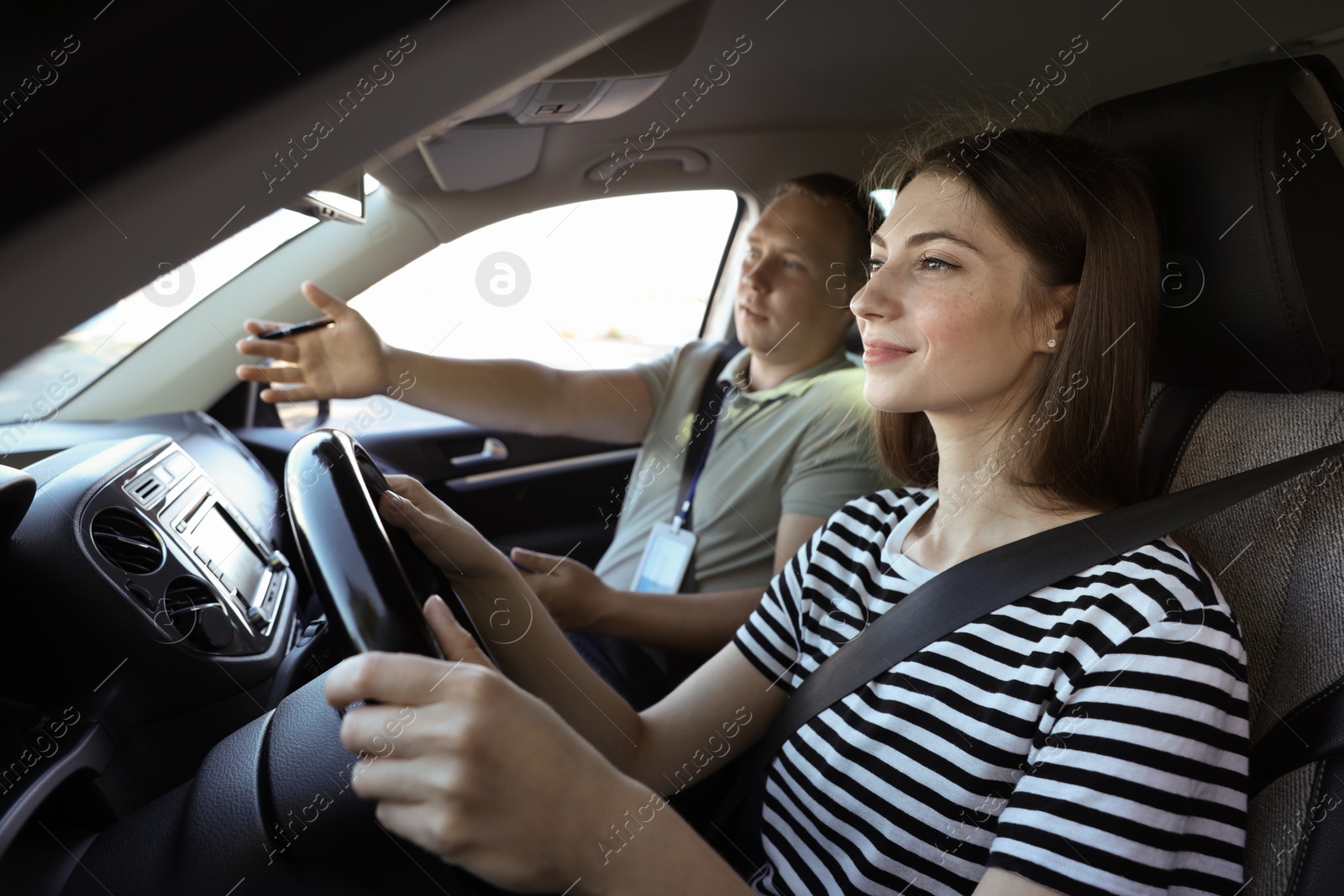 Photo of Driving school. Student passing driving test with examiner in car