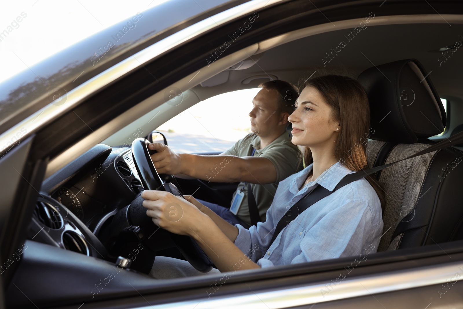 Photo of Driving school. Student passing driving test with examiner in car