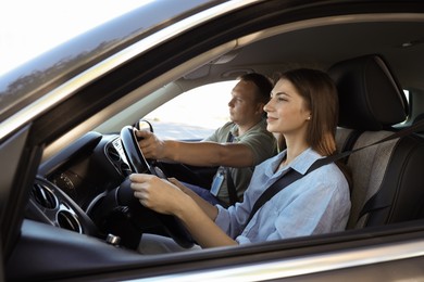 Photo of Driving school. Student passing driving test with examiner in car