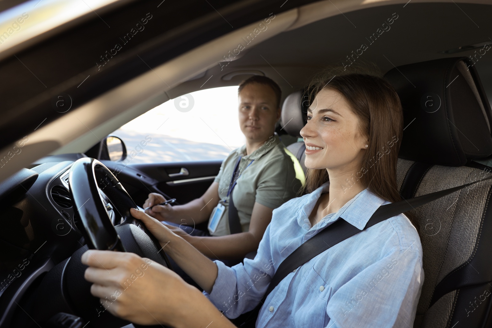 Photo of Driving school. Student passing driving test with examiner in car