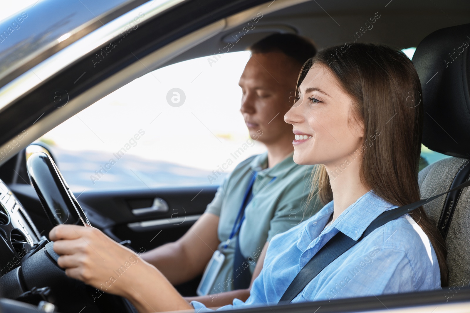 Photo of Driving school. Student passing driving test with examiner in car