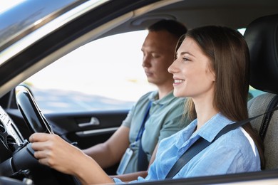 Driving school. Student passing driving test with examiner in car