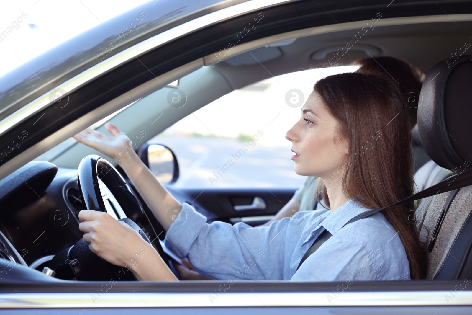 Photo of Driving school. Student passing driving test with examiner in car