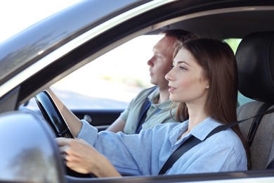 Driving school. Student passing driving test with examiner in car