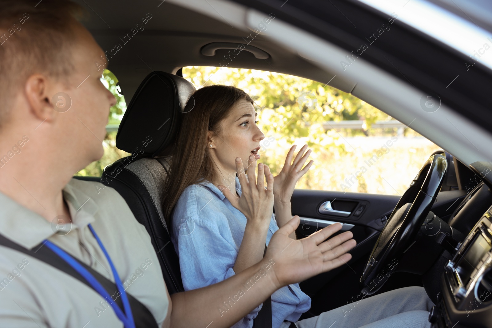 Photo of Driving school. Emotional woman having driving lesson