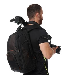 Photographer with backpack, tripod and camera on white background