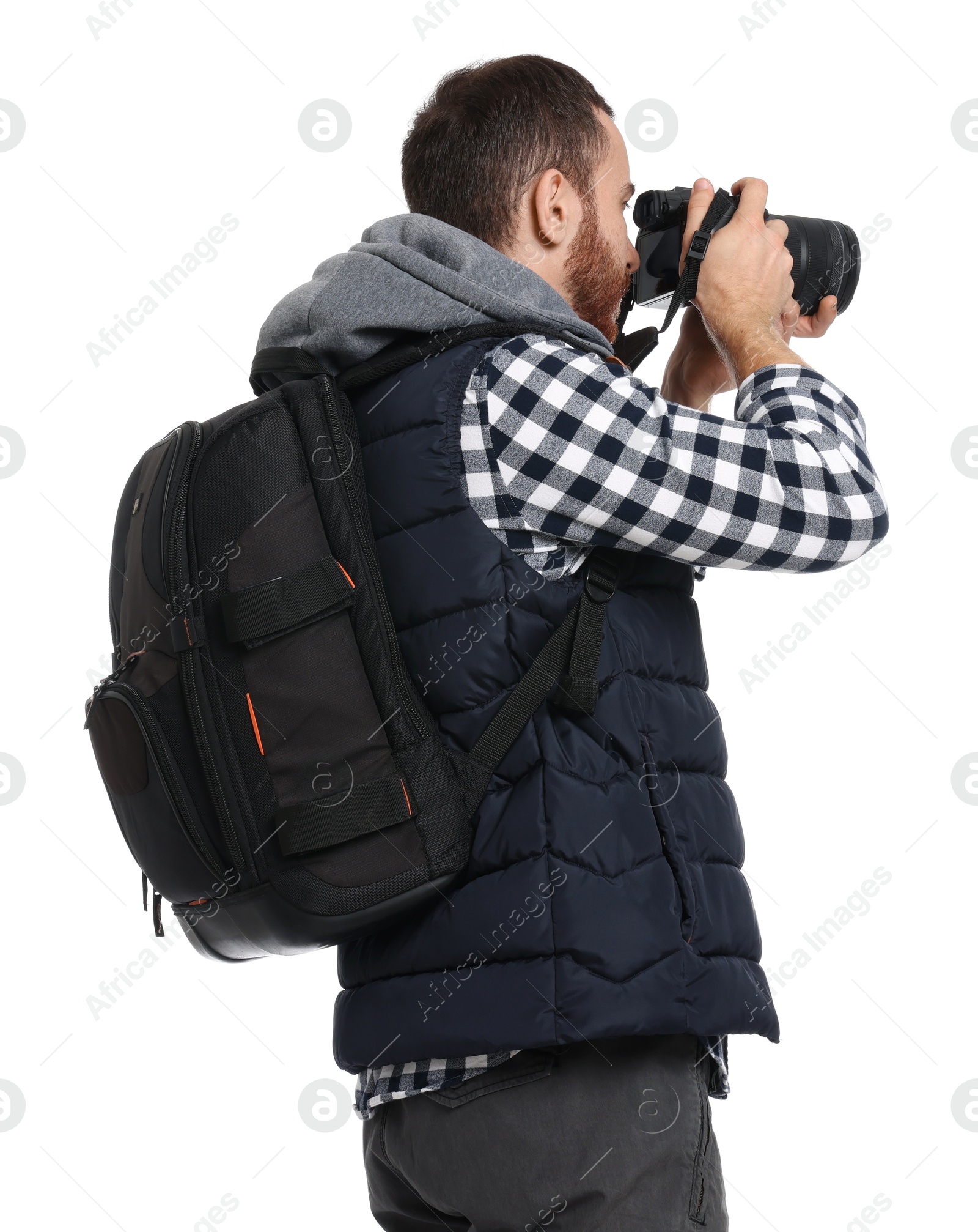 Photo of Photographer with backpack and camera taking picture on white background, back view