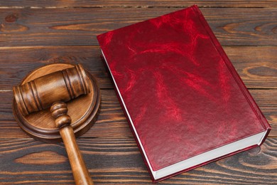 Photo of Book and judge's gavel on wooden table