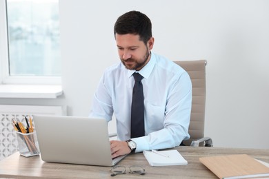 Photo of Portrait of businessman working at table in office