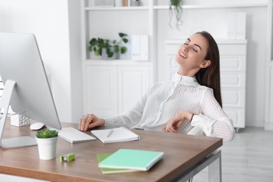 Photo of Beautiful businesswoman relaxing at table in office. Break time