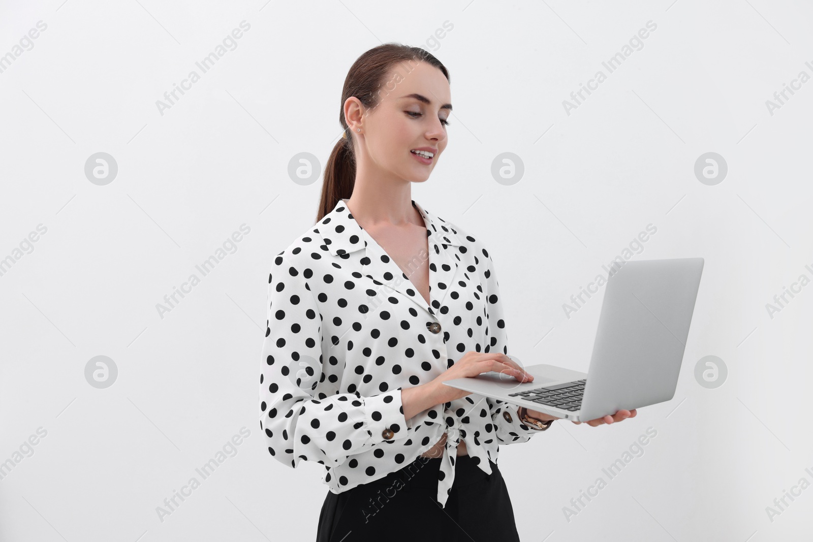 Photo of Smiling businesswoman working with laptop on white background