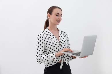 Photo of Smiling businesswoman working with laptop on white background