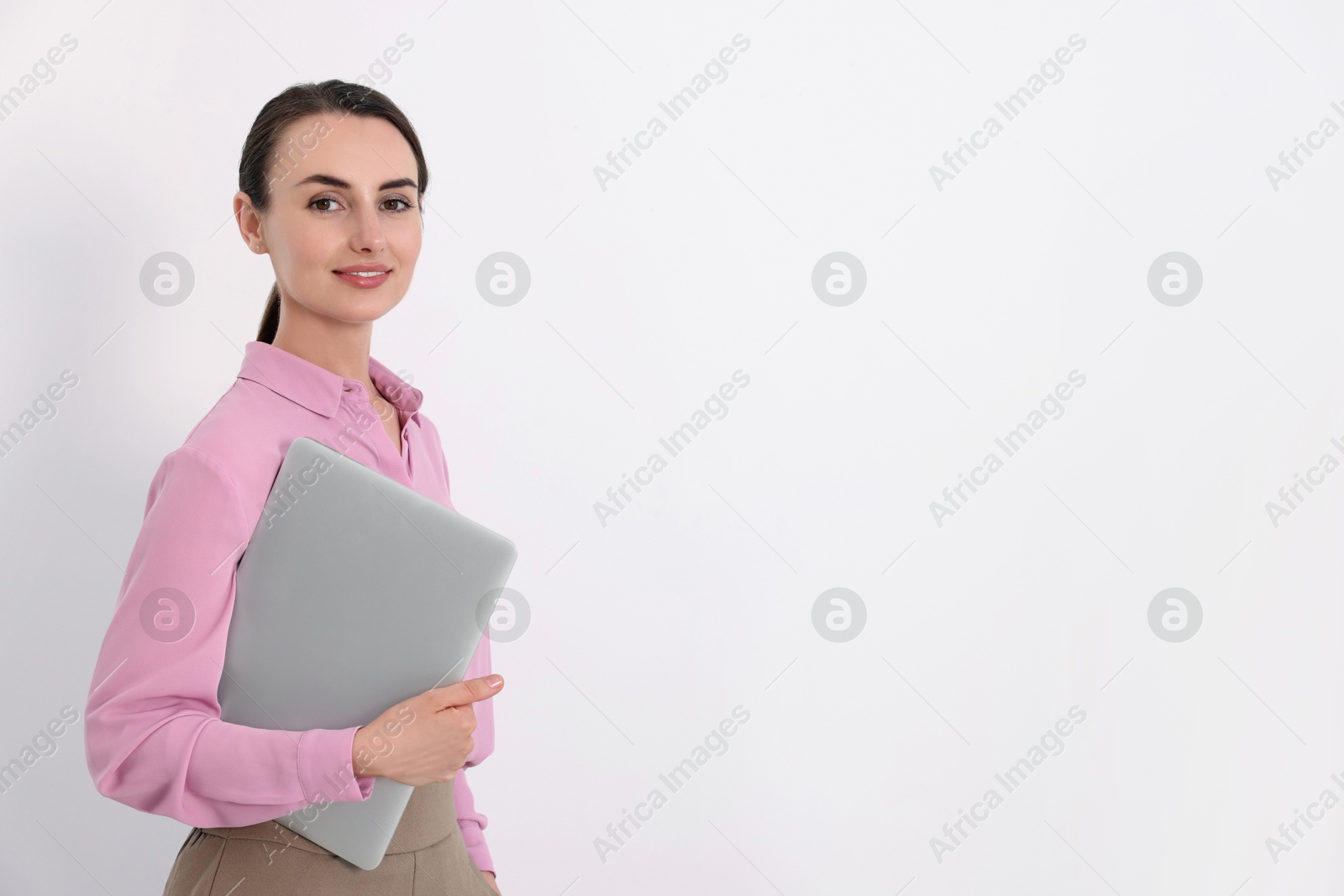 Photo of Portrait of smiling businesswoman with laptop on white background. Space for text