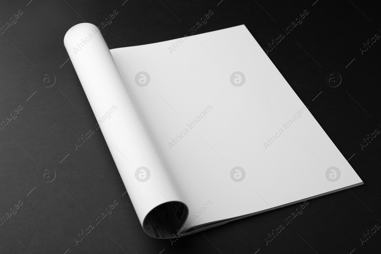 Photo of Open magazine with blank page on black background. Mockup for design