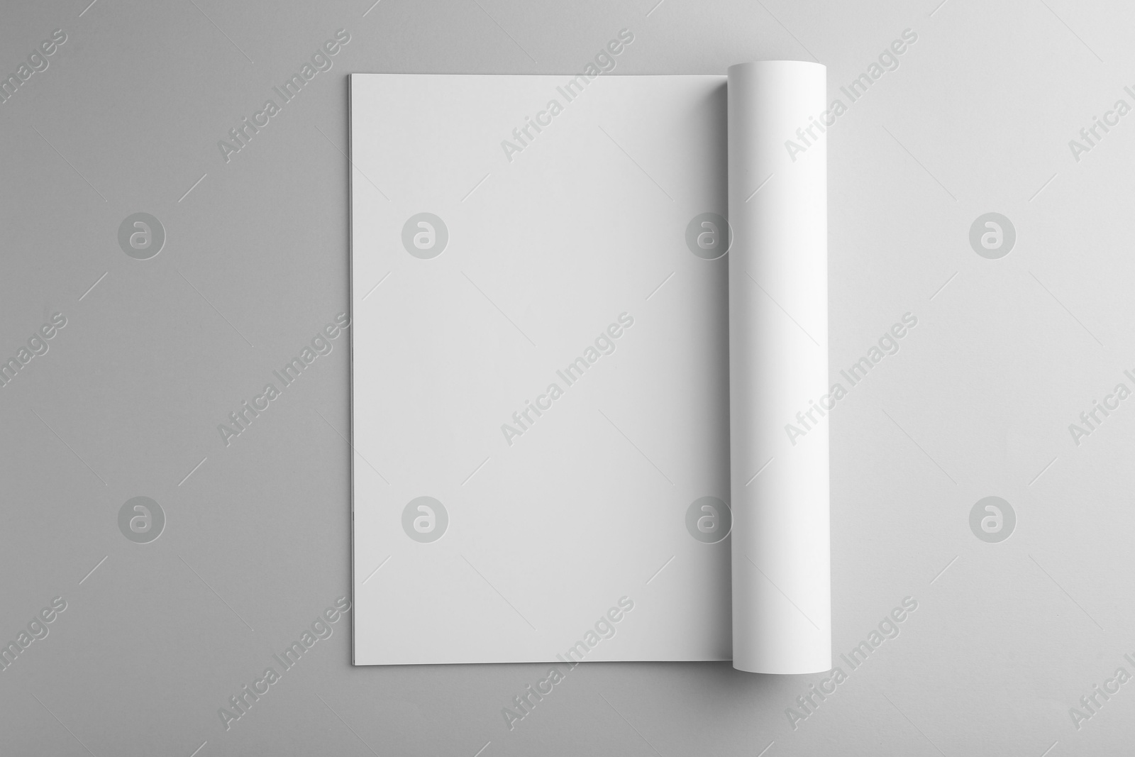 Photo of Open magazine with blank page on grey background, top view. Mockup for design