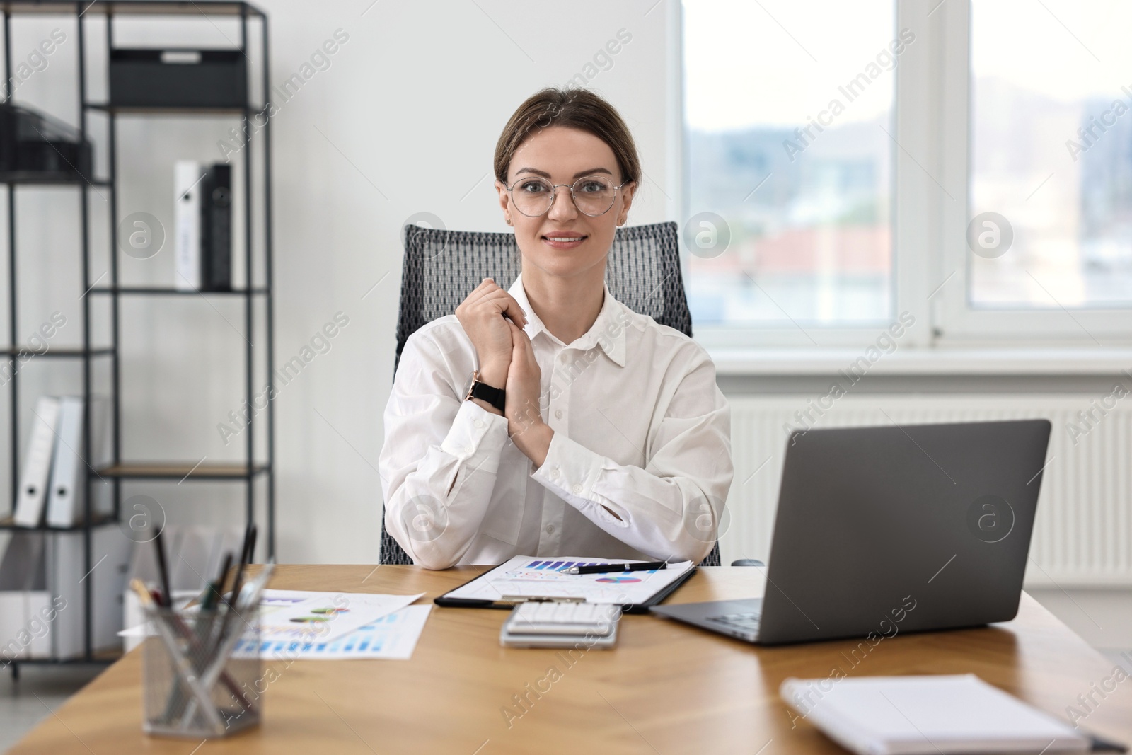 Photo of Portrait of banker at wooden table in office