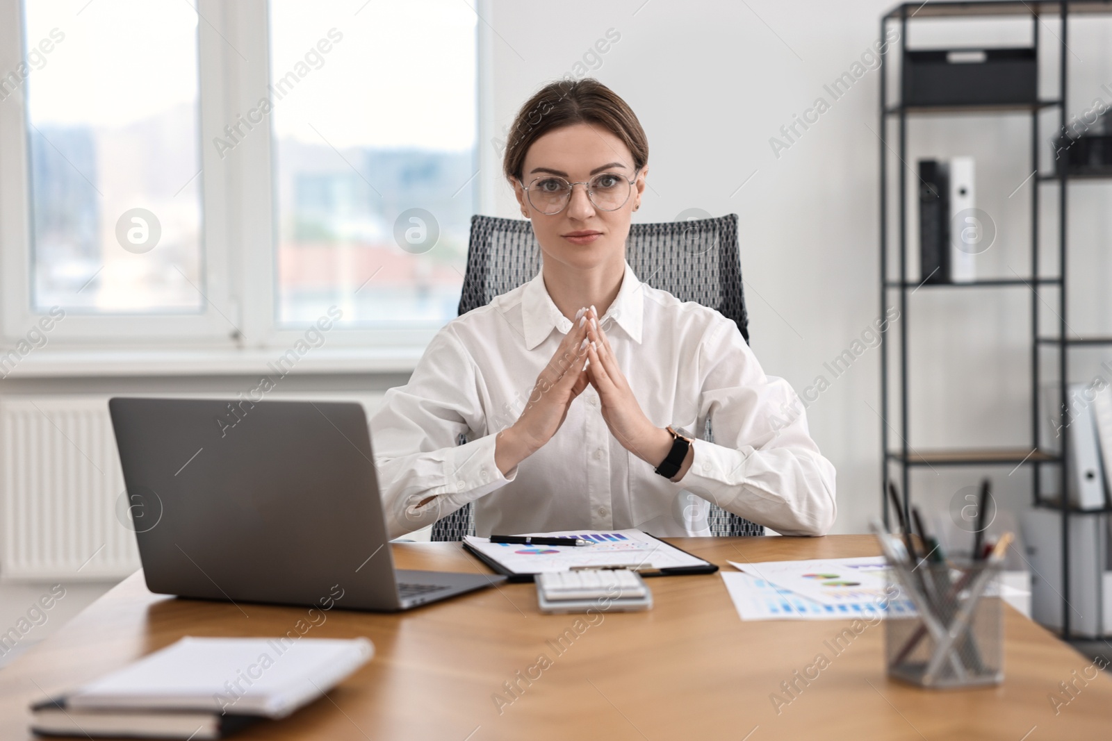 Photo of Portrait of banker at wooden table in office