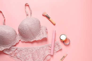 Photo of Elegant lace women's underwear and cosmetics on pink background, flat lay