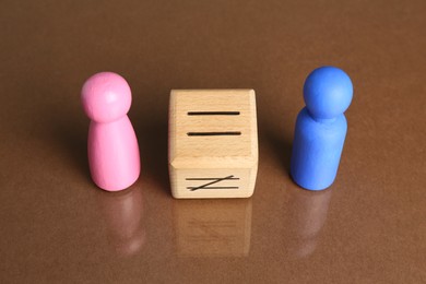 Gender equality concept. Male and female figures on brown background