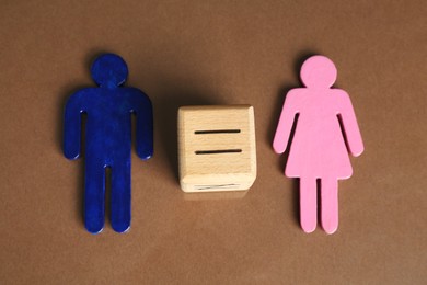 Gender equality concept. Male and female figures on brown background, above view