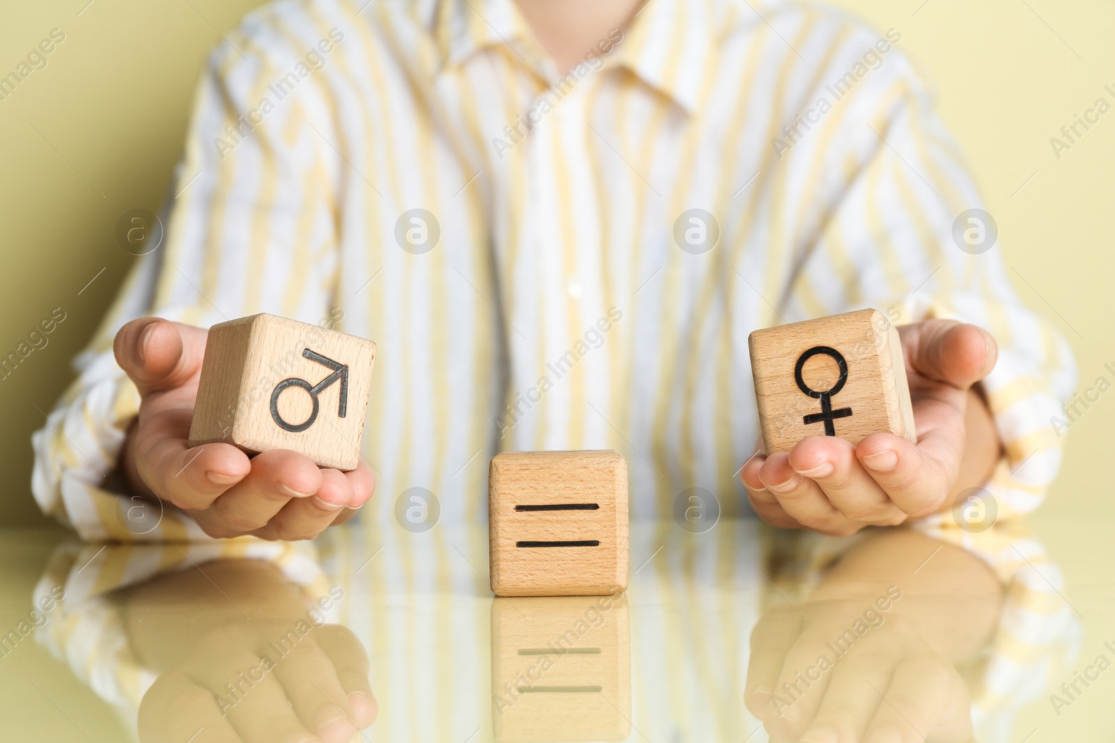 Photo of Gender equality concept. Woman with wooden cubes of male and female symbols at table, closeup