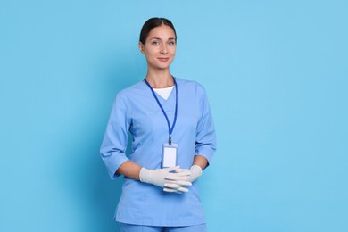 Photo of Nurse in medical uniform on light blue background