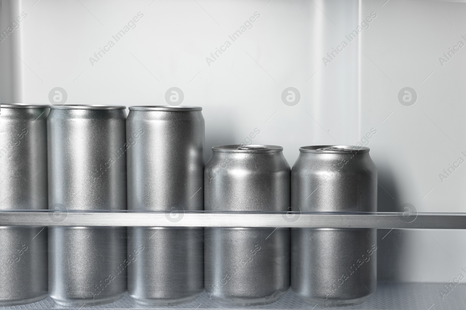 Photo of Many cans of beer in refrigerator, closeup