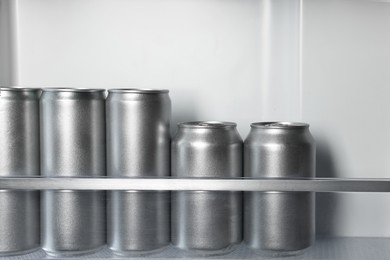 Many cans of beer in refrigerator, closeup