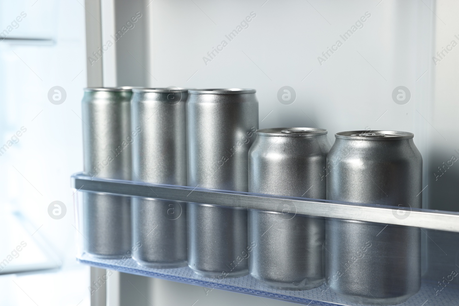 Photo of Many cans of beer in refrigerator, closeup