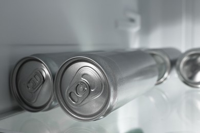 Photo of Many cans of beer in refrigerator, closeup