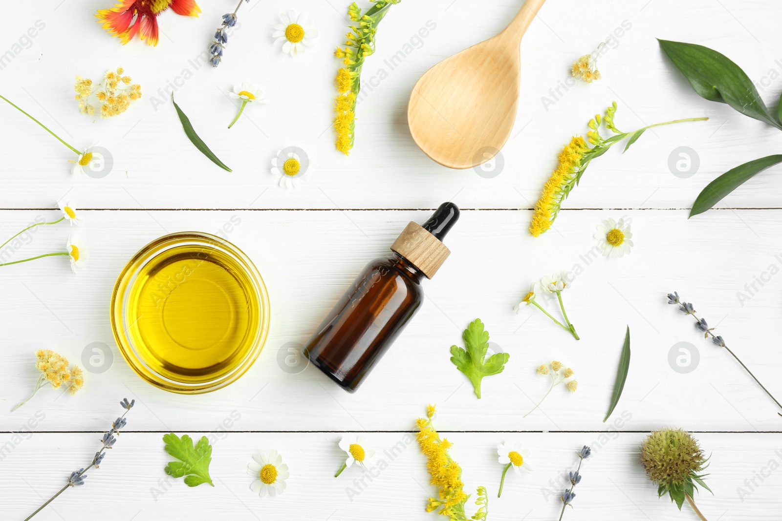 Photo of Tinctures and medicinal herbs on white wooden table, flat lay