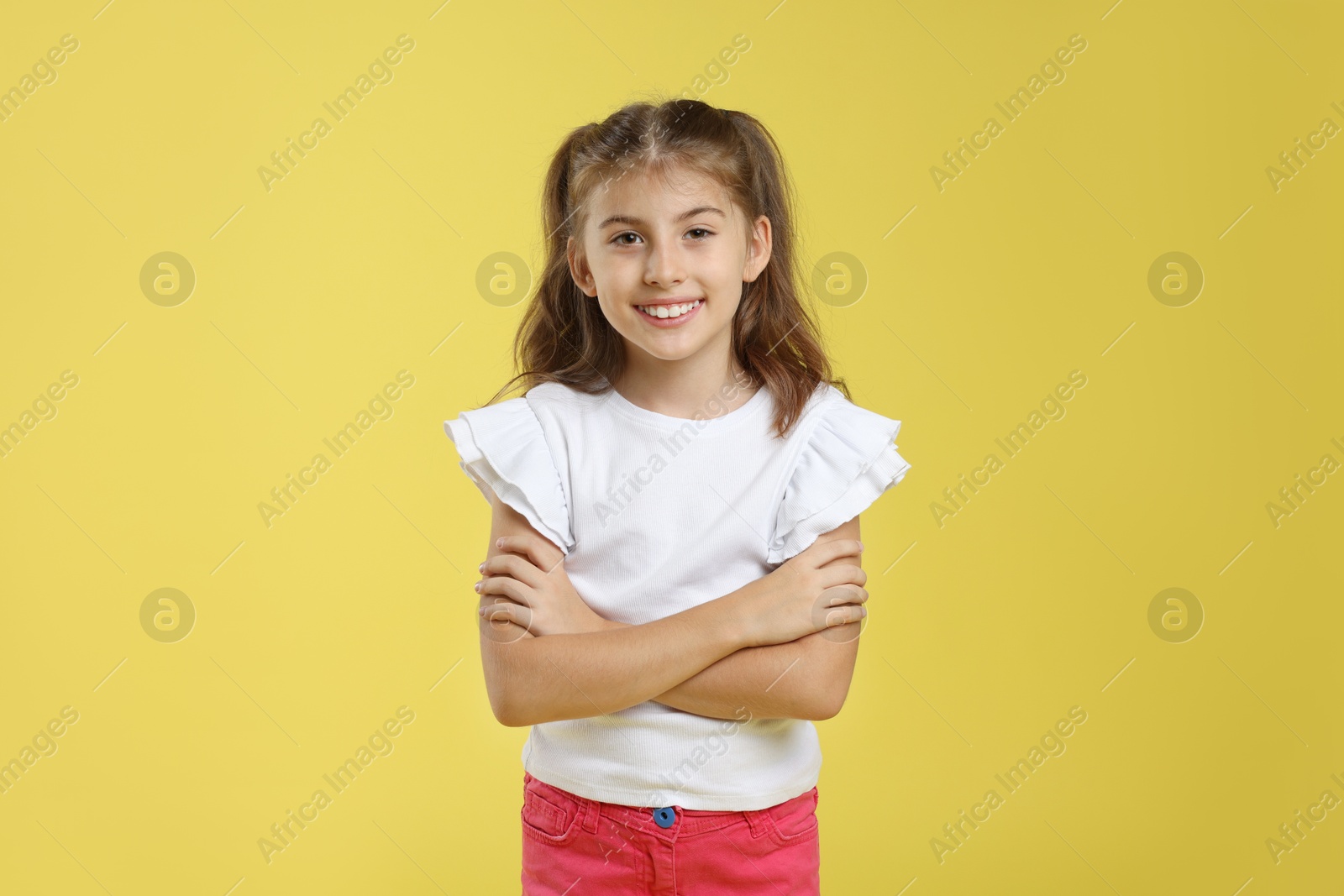 Photo of Portrait of cute girl on yellow background