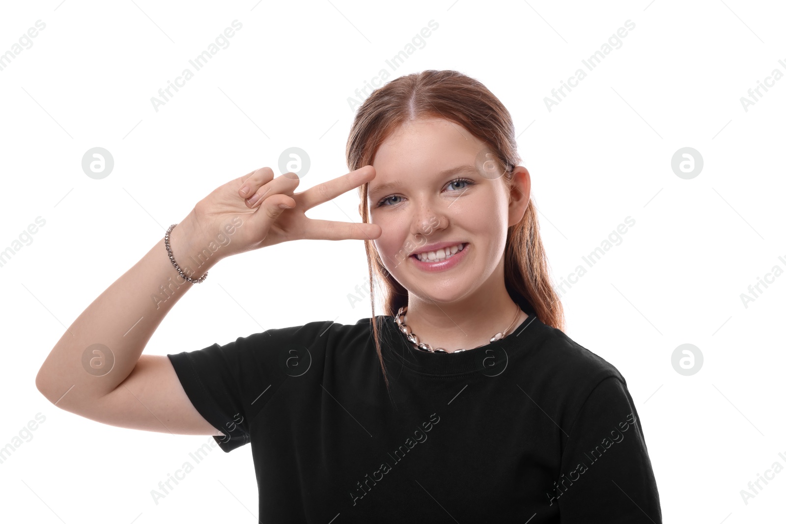 Photo of Teenage girl showing v-sign on white background