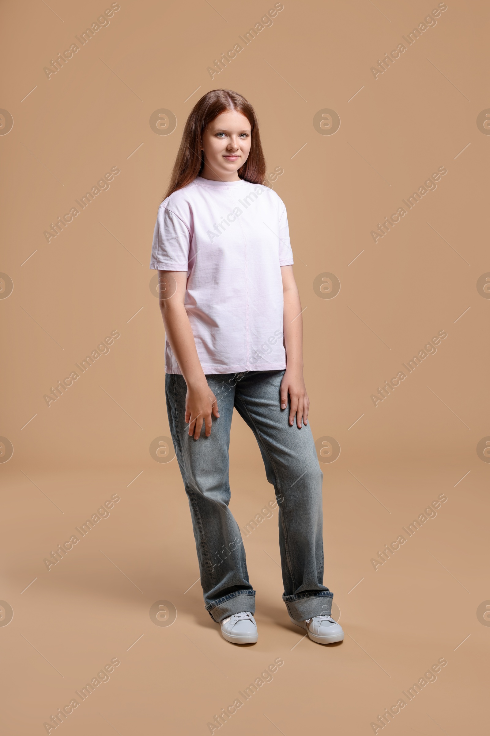 Photo of Full length portrait of teenage girl on beige background