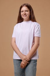 Portrait of teenage girl on beige background