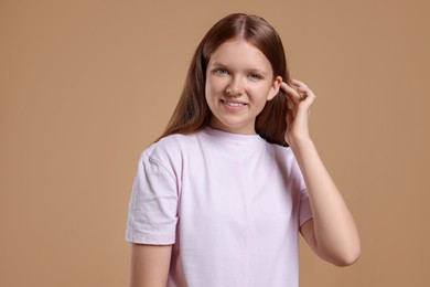 Photo of Portrait of teenage girl on beige background