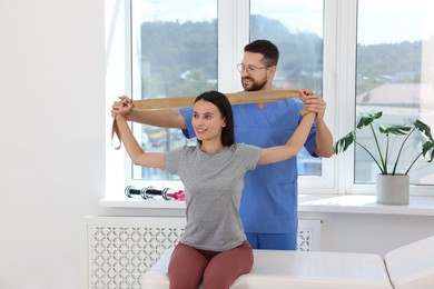 Photo of Physiotherapist working with patient in rehabilitation center