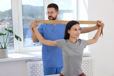 Photo of Physiotherapist working with patient in rehabilitation center