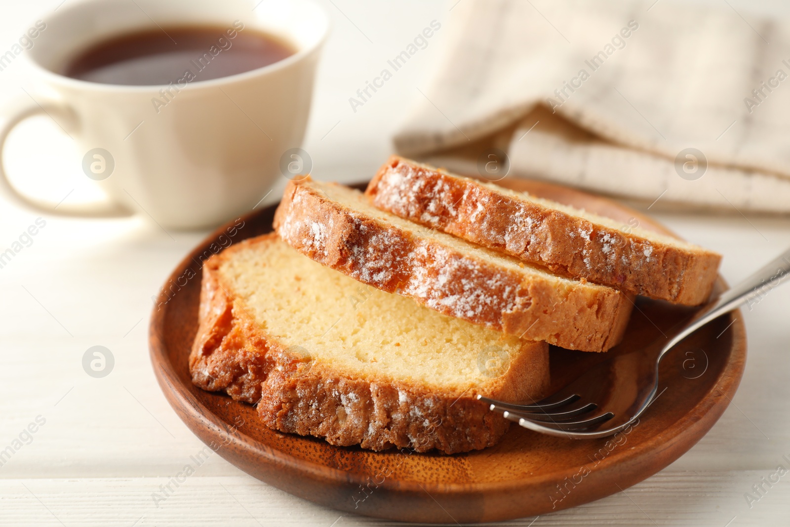 Photo of Freshly baked sponge cake on white wooden table, closeup