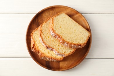 Photo of Freshly baked sponge cake on white wooden table, top view