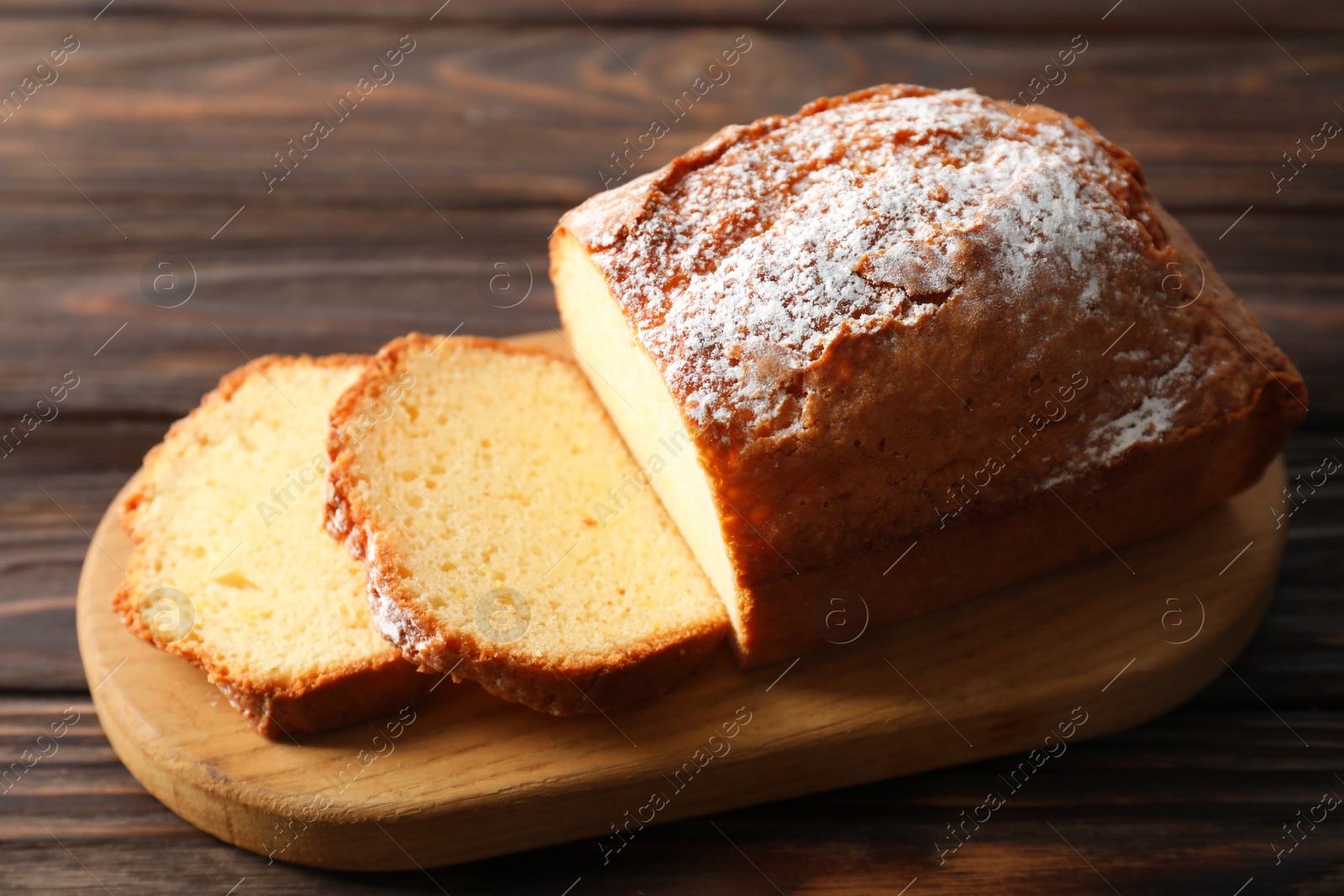 Photo of Freshly baked sponge cake on wooden table