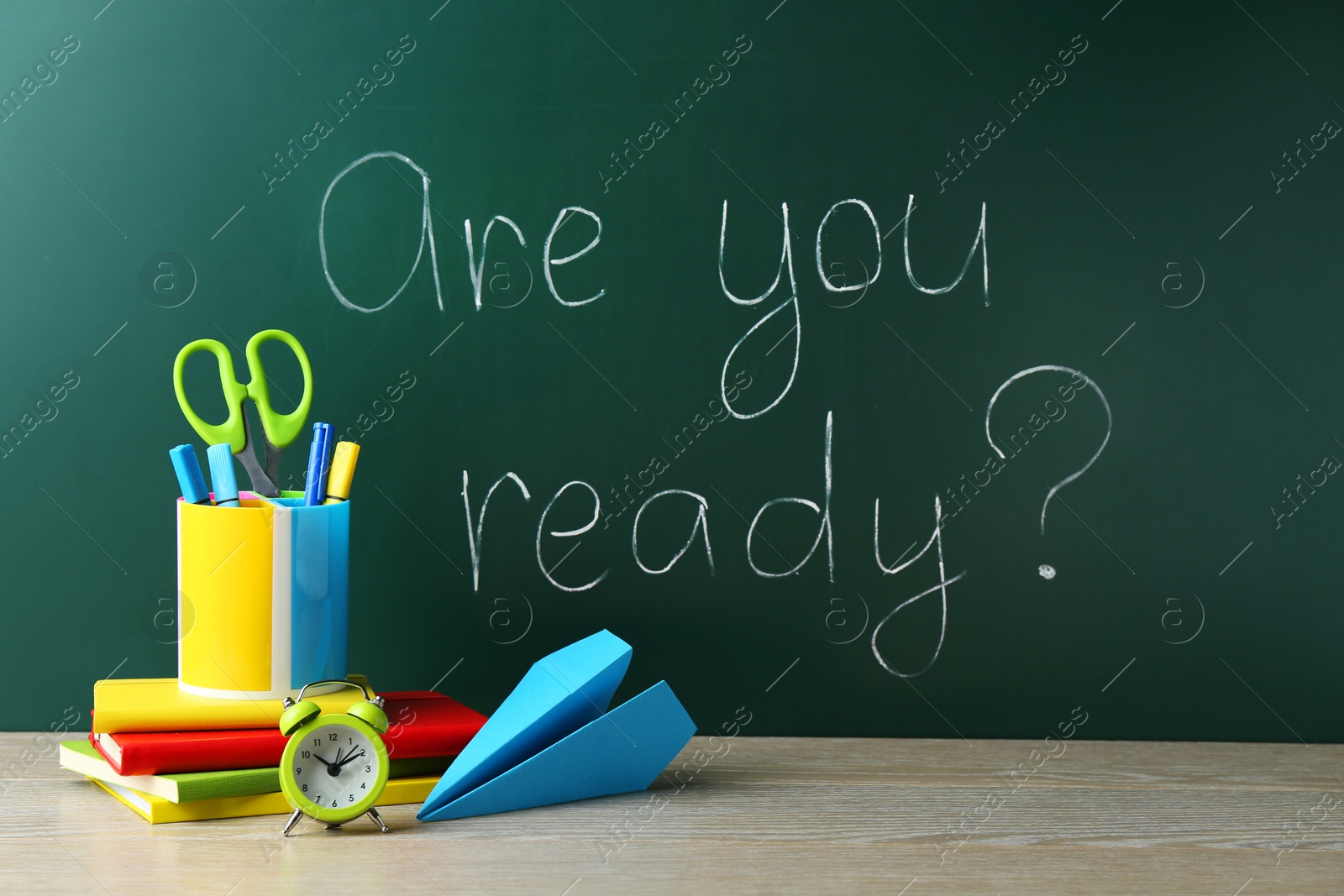 Photo of Chalkboard with question Are You Ready and stationery on wooden desk