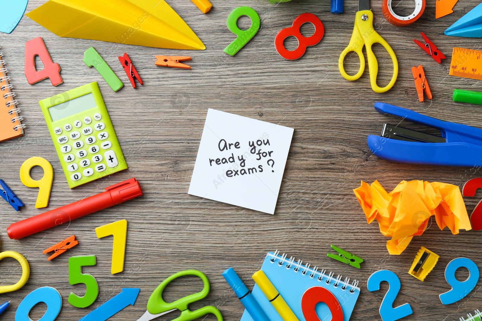 Photo of Note with question Are You Ready For Exams and stationery on wooden desk, flat lay