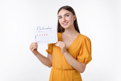 Photo of Woman holding calendar with marked menstrual cycle days on white background