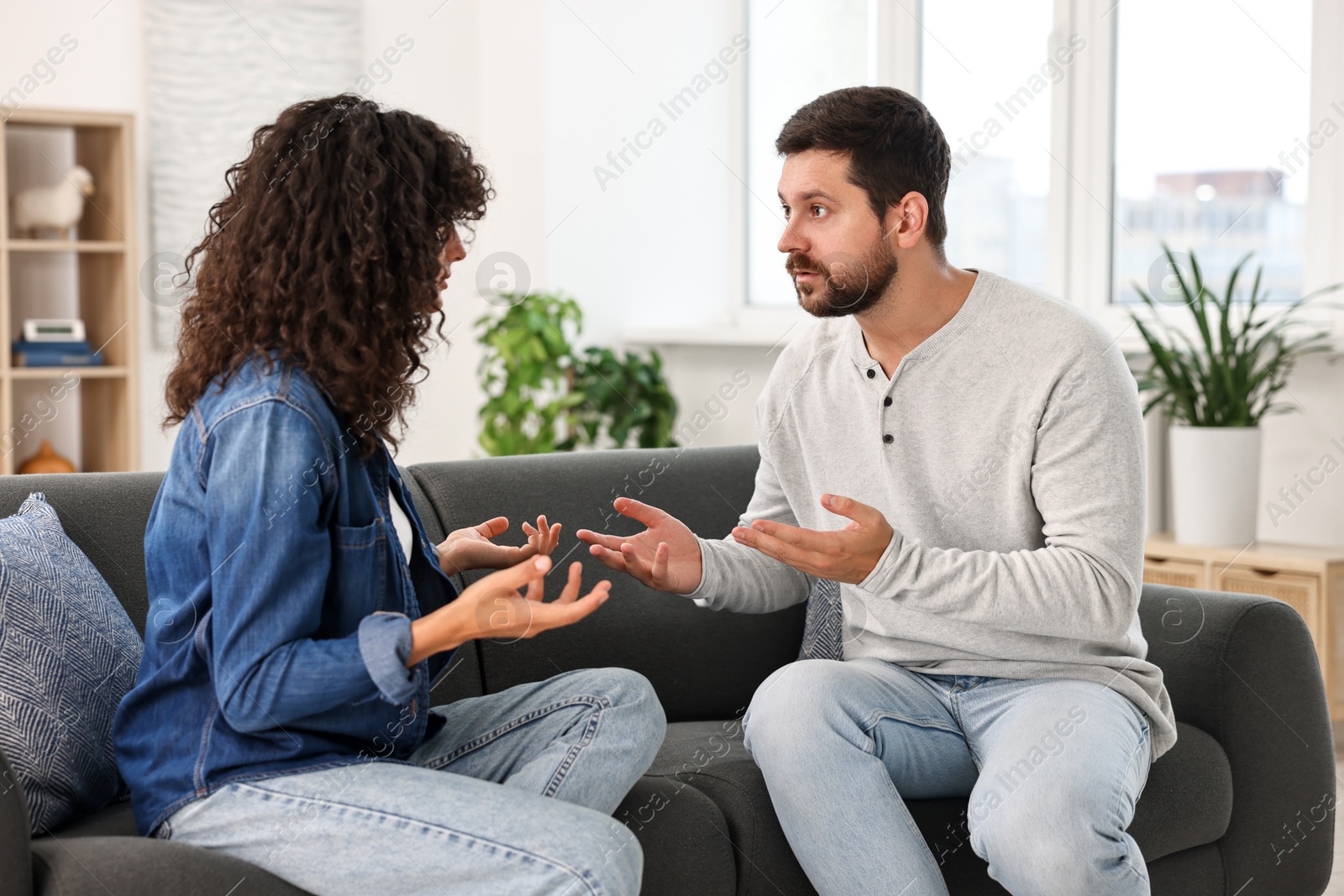 Photo of Emotional couple arguing at home. Relationship problems