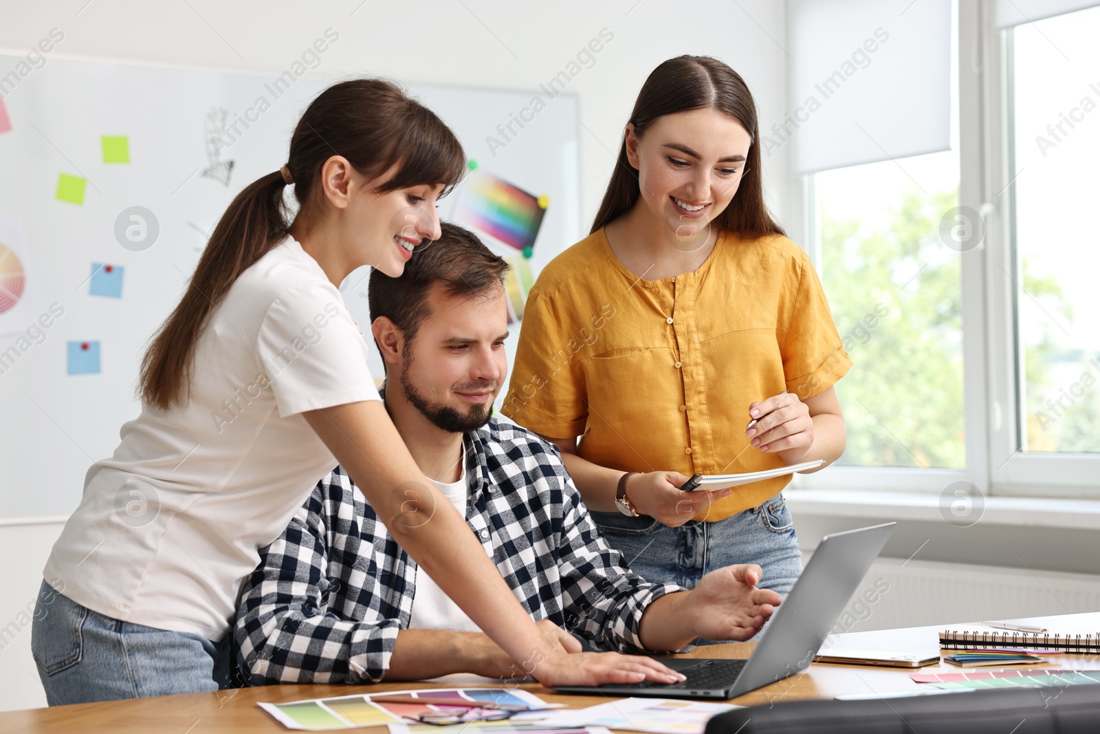 Photo of Group of designers working together in office