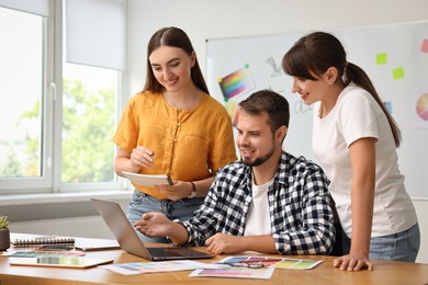 Photo of Group of designers working together in office